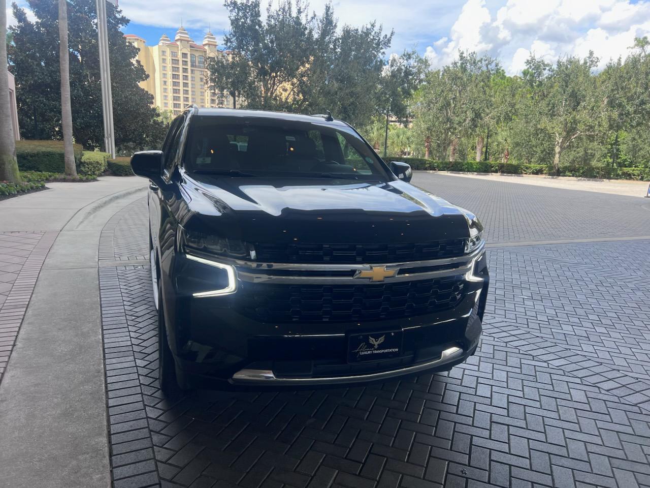 Black luxury SUV parked outdoors, ready for professional airport pickup.